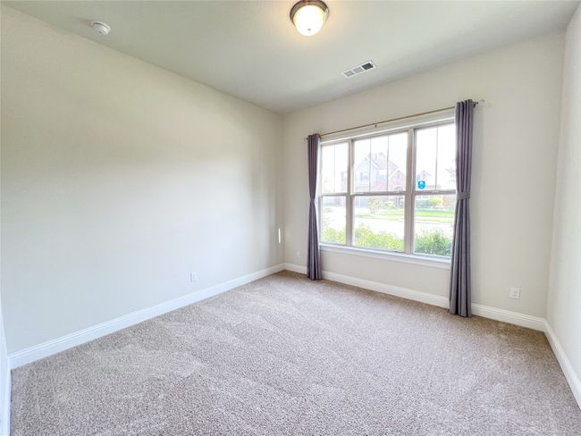Spare room with a smoke detector and light colored carpet | Image 12