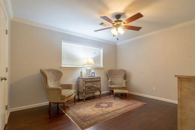 Living area featuring ceiling fan, wood-type flooring, ornamental molding, and baseboards | Image 18