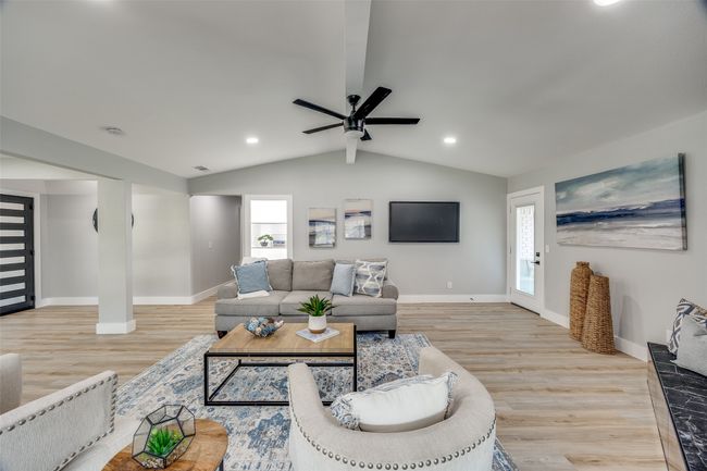 Living room featuring light wood-style flooring, plenty of natural light, a ceiling fan, and recessed lighting | Image 8