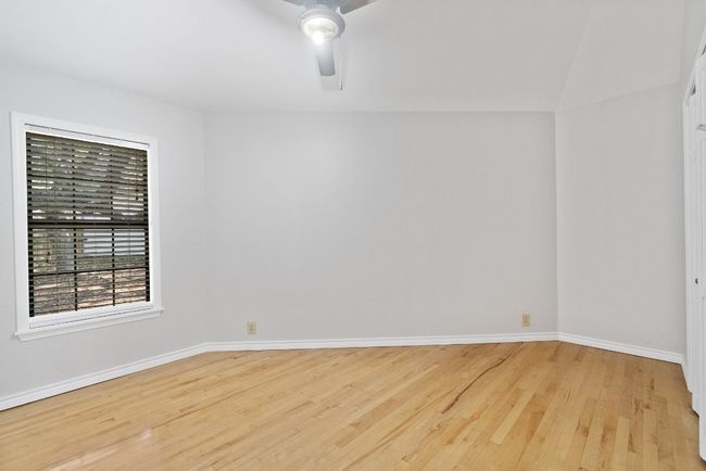 Empty room featuring wood finished floors, a ceiling fan, and baseboards | Image 16