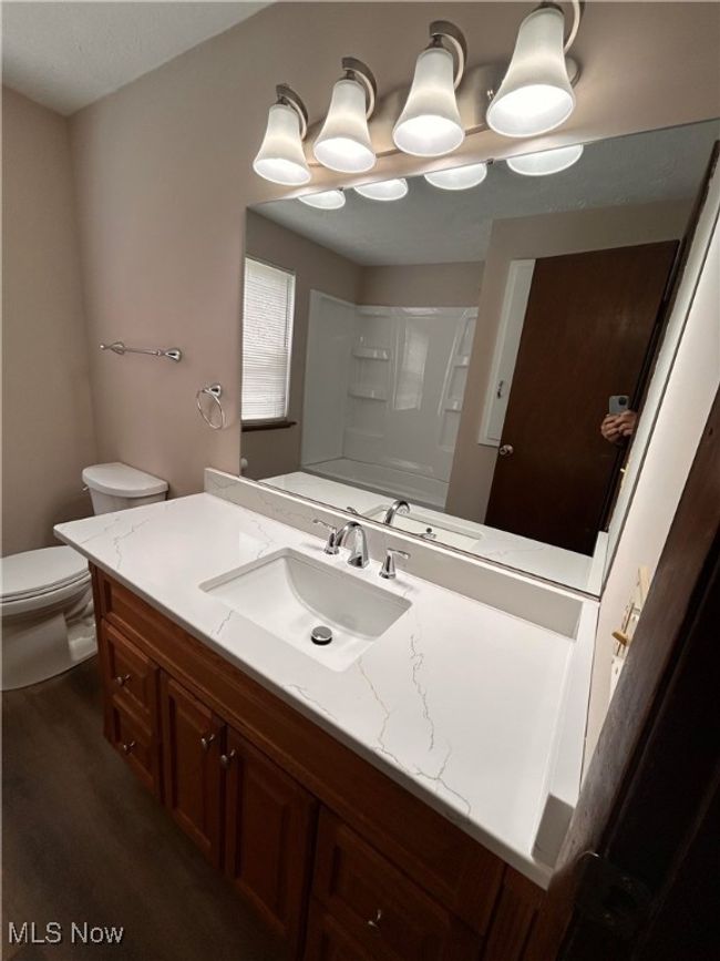 Bathroom with walk in shower, wood finished floors, toilet, and vanity | Image 11