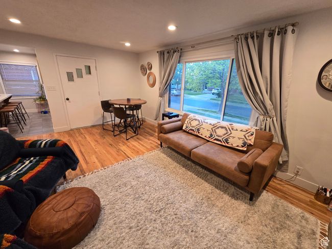 Living room with recessed lighting, light wood finished floors, and baseboards | Image 10