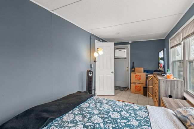 A different view of the primary bedroom showcasing the easy access to the deck. | Image 8