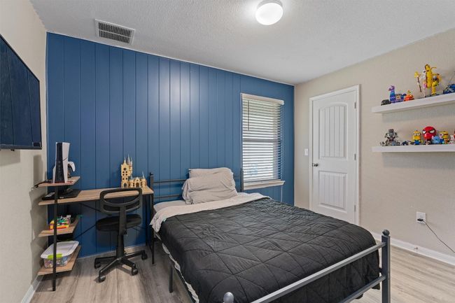 Bedroom featuring wood finished floors and baseboards | Image 18
