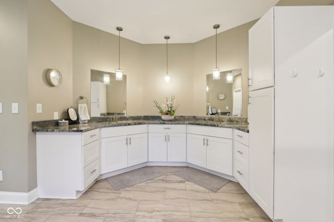 bathroom with marble finish floor, double vanity, a high ceiling, and a sink | Image 29