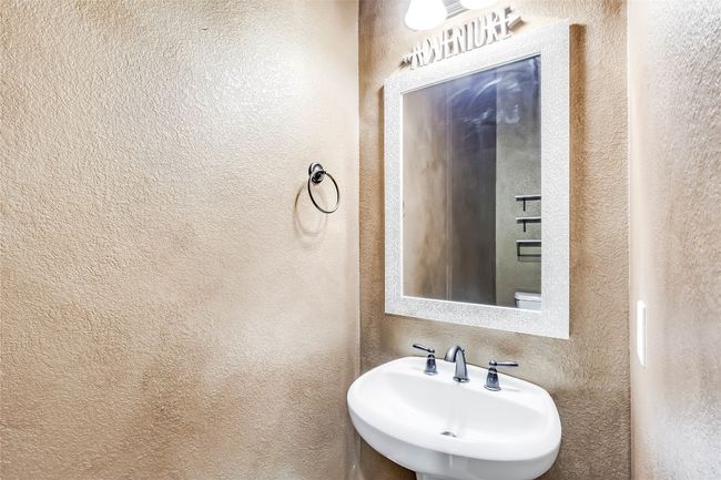 Bathroom featuring a textured wall and a sink | Image 19