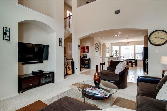 Living room with a towering ceiling and light colored carpet | Image 18
