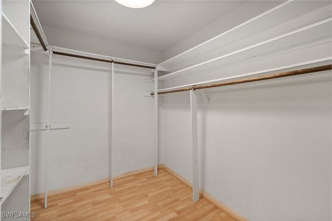 Spacious closet featuring light wood-type flooring | Image 22
