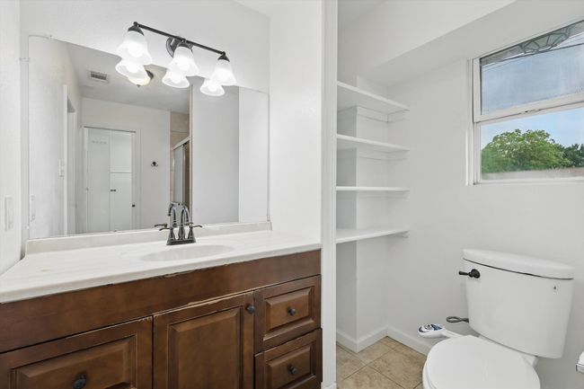 Bathroom with vanity, tile patterned flooring, and a shower with door | Image 14