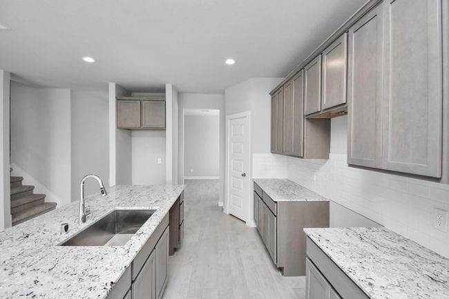 Discover another perspective of this stunning kitchen, generously appointed with an abundance of counter space. | Image 16