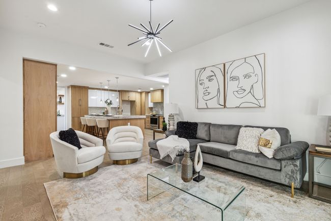 Living room with visible vents, baseboards, a chandelier, light wood-type flooring, and recessed lighting | Image 18