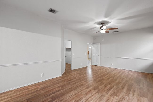 Primary bedroom with ceiling fan and walk-in closet | Image 21