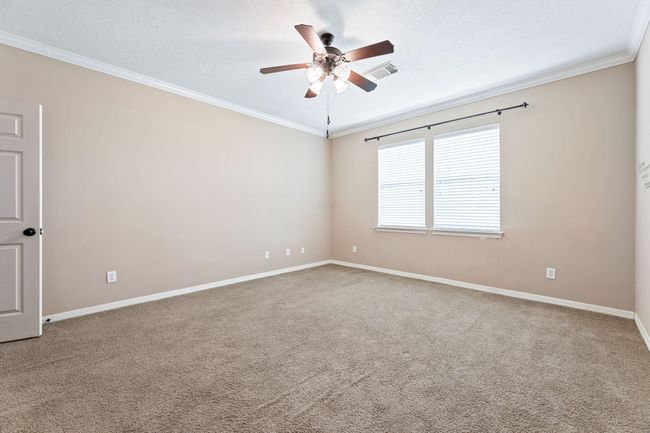 Primary bedroom with ceiling fan | Image 23