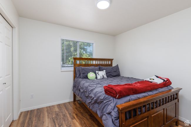 Bedroom featuring wood finished floors and baseboards | Image 14