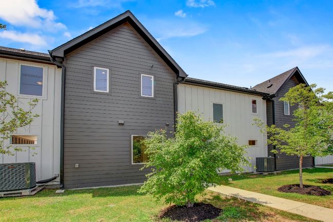 View of property exterior with central AC unit and a lawn | Image 31