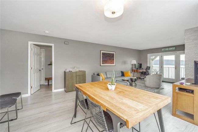 Dining area with primary bedroom suite door in background. | Image 8