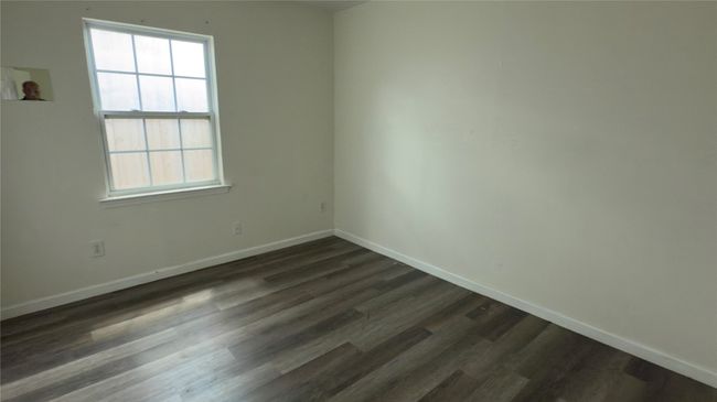Unfurnished room with baseboards and dark wood-style floors | Image 25