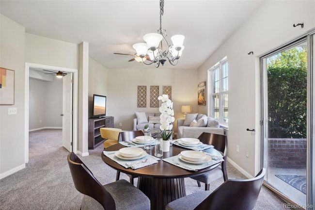 View of the dining area looking towards the living room and primary bedroom entry. Most furnishings are negotiable. | Image 10