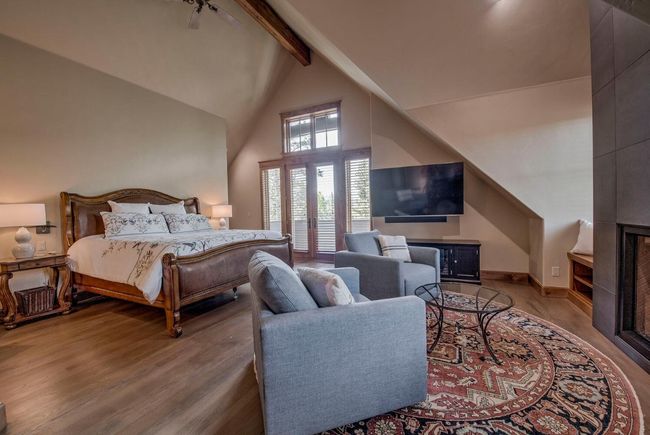 Step into the primary bedroom, with 2 bathrooms, 2 closets, and a sitting area. Enjoy a good book by the beautiful statement fireplace. | Image 15