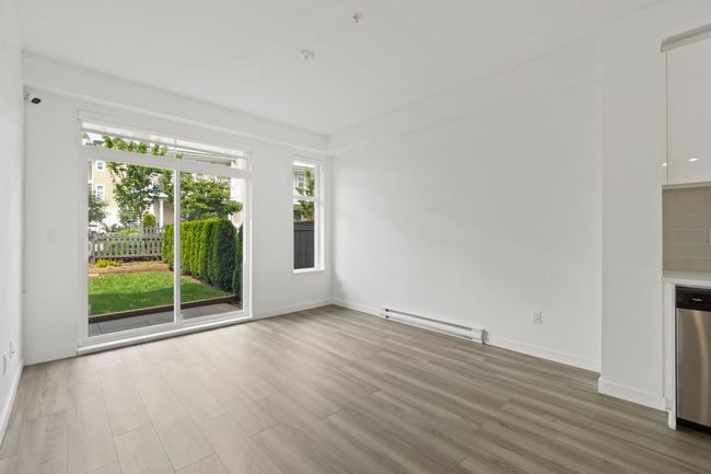 Unfurnished room with a baseboard radiator and wood finished floors | Image 10