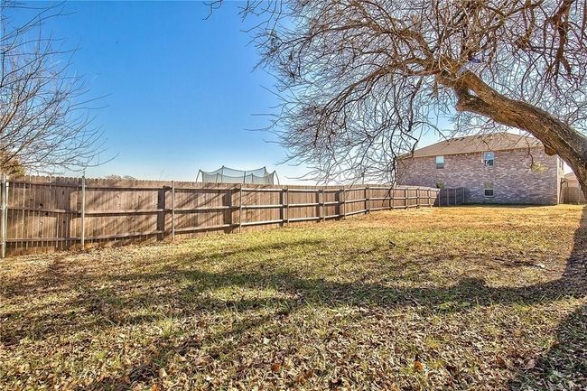 View of fenced backyard | Image 18