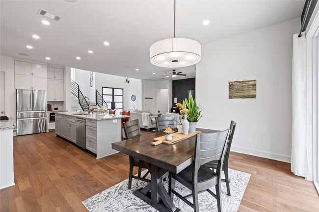 Dining room featuring a ceiling fan, recessed lighting, wood finished floors, stairway, and baseboards | Image 12