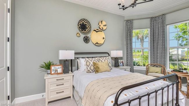 Bedroom featuring baseboards, a notable chandelier, light carpet, and crown molding | Image 13