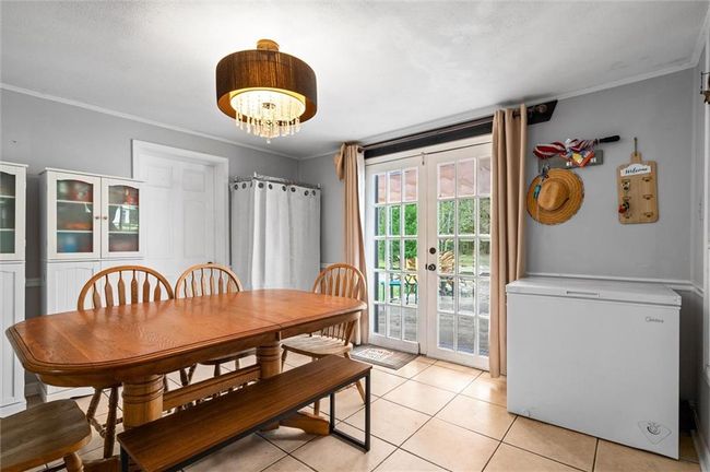 Dining space with beautiful french doors and chandelier. | Image 7