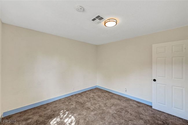 Empty room with carpet floors and a smoke detector | Image 23