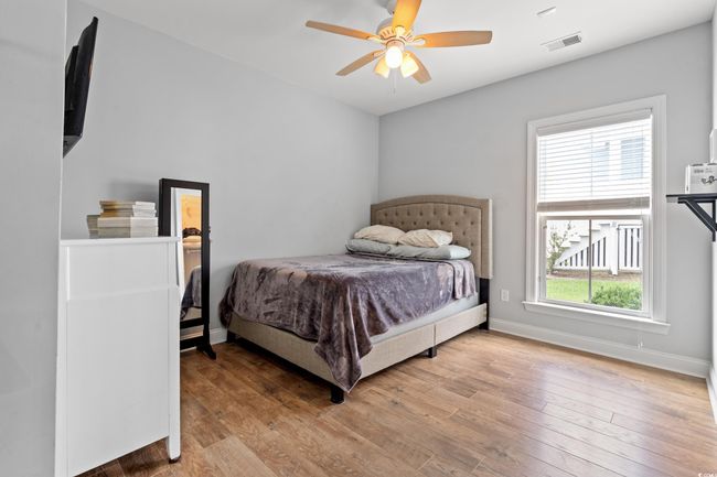 Bedroom with wood finished floors and a ceiling fan | Image 18