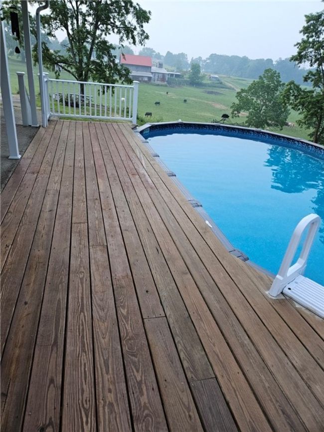 Covered rear deck to the above ground pool | Image 24