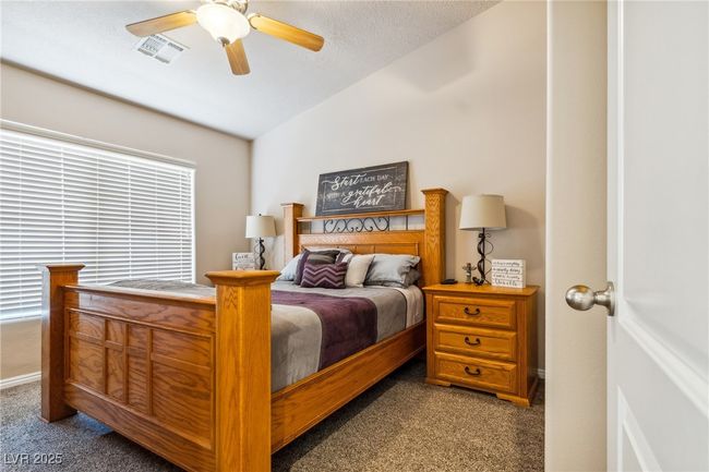 Bedroom with carpet flooring, vaulted ceiling, and a ceiling fan | Image 24