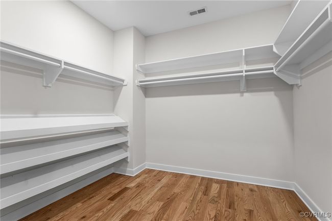 Spacious closet featuring wood finished floors | Image 36
