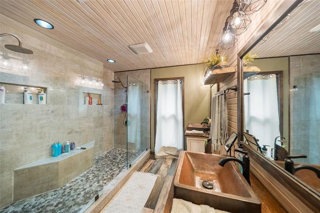 Retreat to the luxurious primary bathroom, where elegance and comfort unite to create a spa-like experience. | Image 29