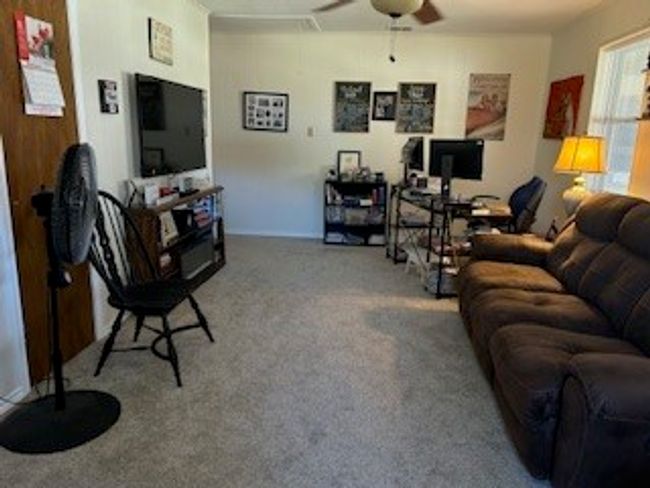 Guest house Living room featuring ceiling fan, carpet floors, and an office area | Image 18