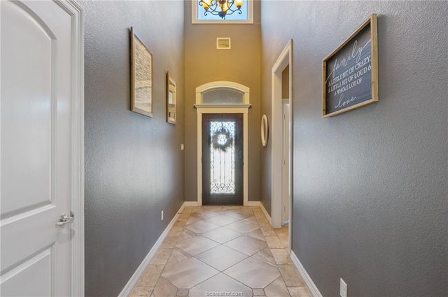 Doorway to outside with a chandelier and light tile patterned flooring | Image 11