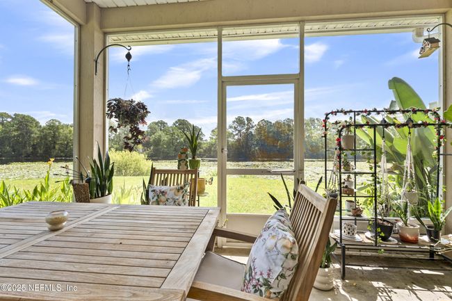 Returning downstairs off dining/kitchen to your covered screened in patio | Image 37