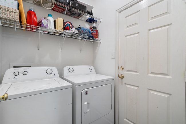 Convenient laundry room at the 2 car garage offers additional storage plus the washer and dryer convey. | Image 27