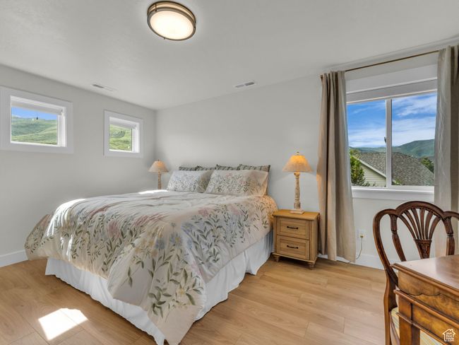 Bedroom featuring light wood-style flooring and baseboards | Image 43