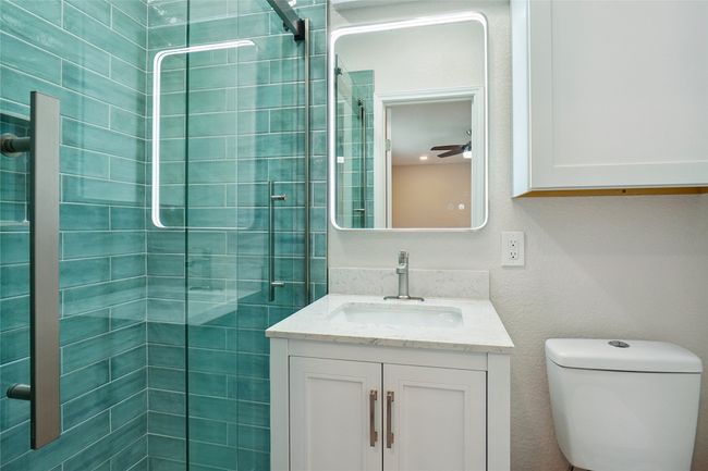 Bathroom with vanity and a tile shower | Image 13