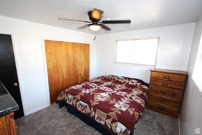 Carpeted bedroom with a closet and a ceiling fan | Image 18