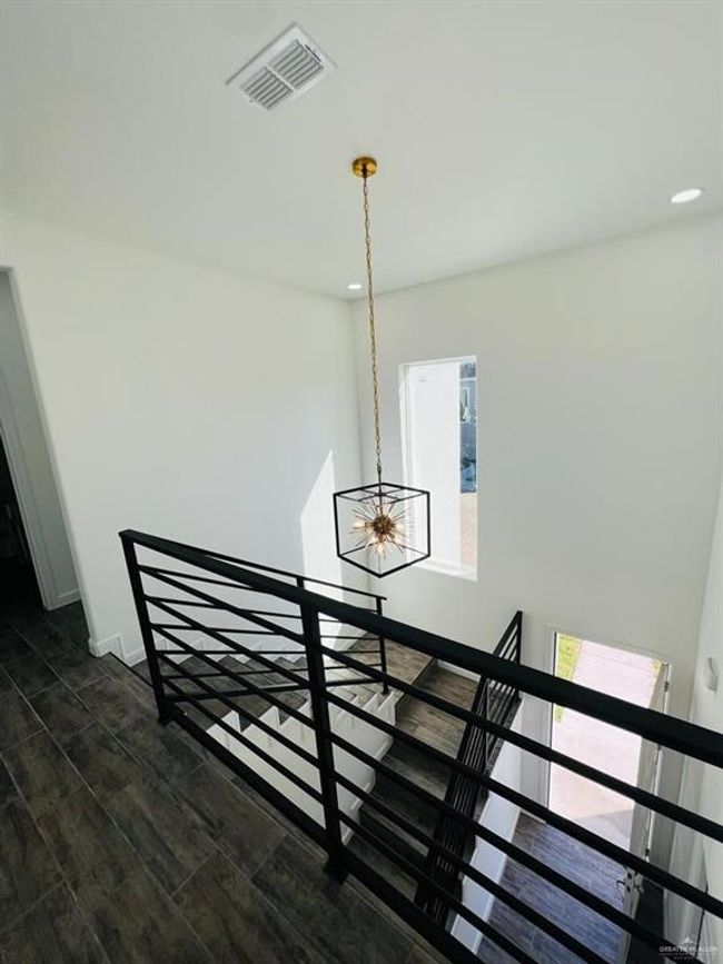 Stairway with an inviting chandelier and hardwood / wood-style floors | Image 13