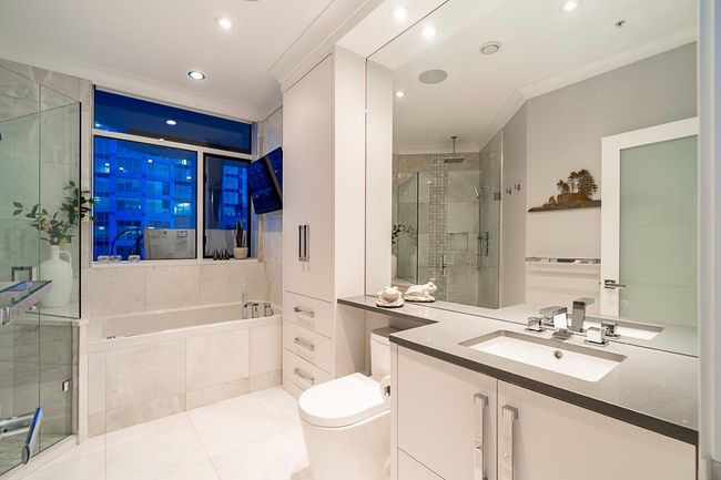 Bathroom featuring ornamental molding, a shower stall, a bath, vanity, and tile patterned flooring | Image 27