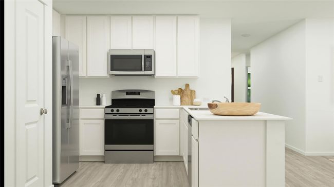 Kitchen featuring stainless steel appliances, a peninsula, light wood-type flooring, and white cabinets | Image 16