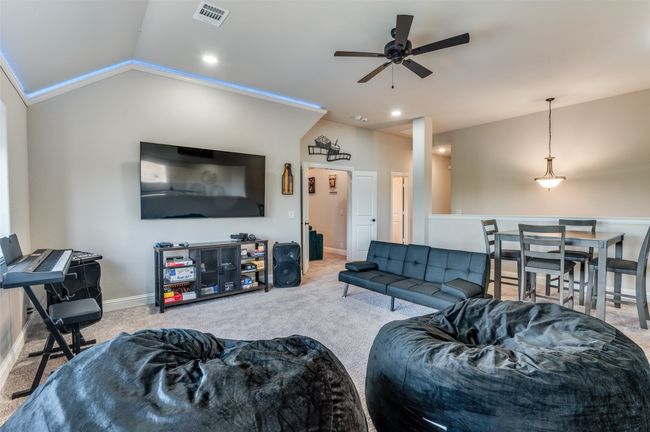 Living area featuring vaulted ceiling, carpet flooring, ceiling fan, and recessed lighting | Image 16