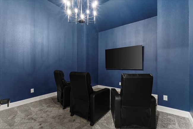Home theater room featuring a chandelier and carpet flooring | Image 9