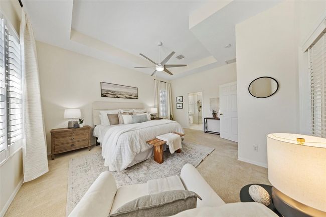 Spacious primary suite overlooking pool and pond. | Image 32