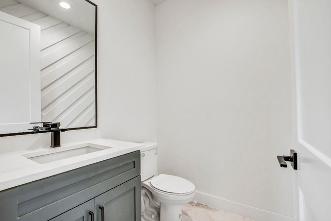 Half bath featuring toilet, vanity, baseboards, and recessed lighting | Image 11