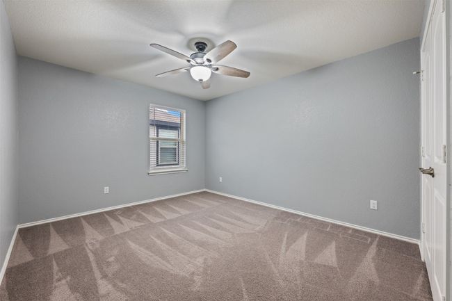 Carpeted spare room featuring baseboards and ceiling fan | Image 28