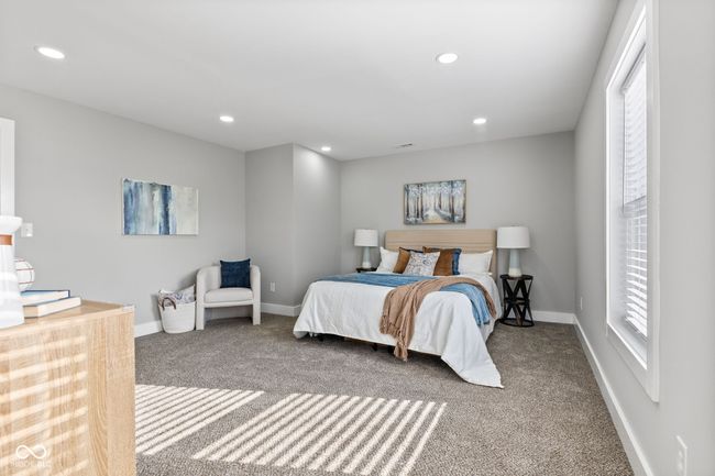 Primary bedroom with tons of natural light, baseboards, recessed lighting, visible vents, and carpet | Image 18